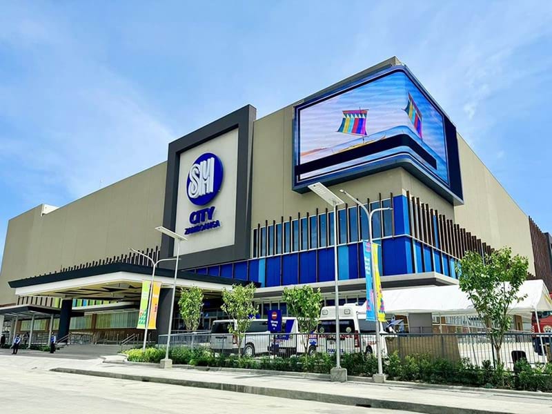 SM City Zamboanga's curved outdoor LED wall anchors the building's exterior facade, extending the mall's visual presence to the surrounding streetscape of Zamboanga City.