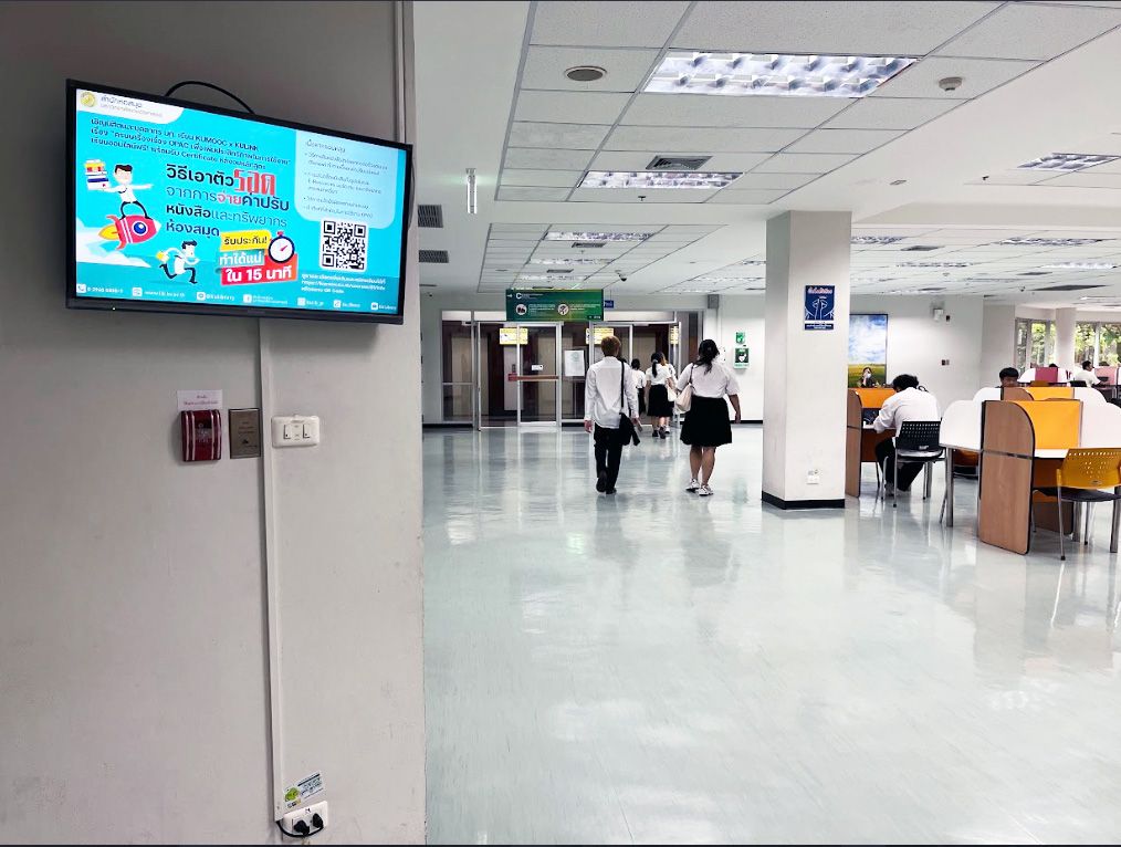 Digital signage displays mounted above the elevator doors on the third floor of Kasetsart University Library, reaching every student who waits for a ride between floors.